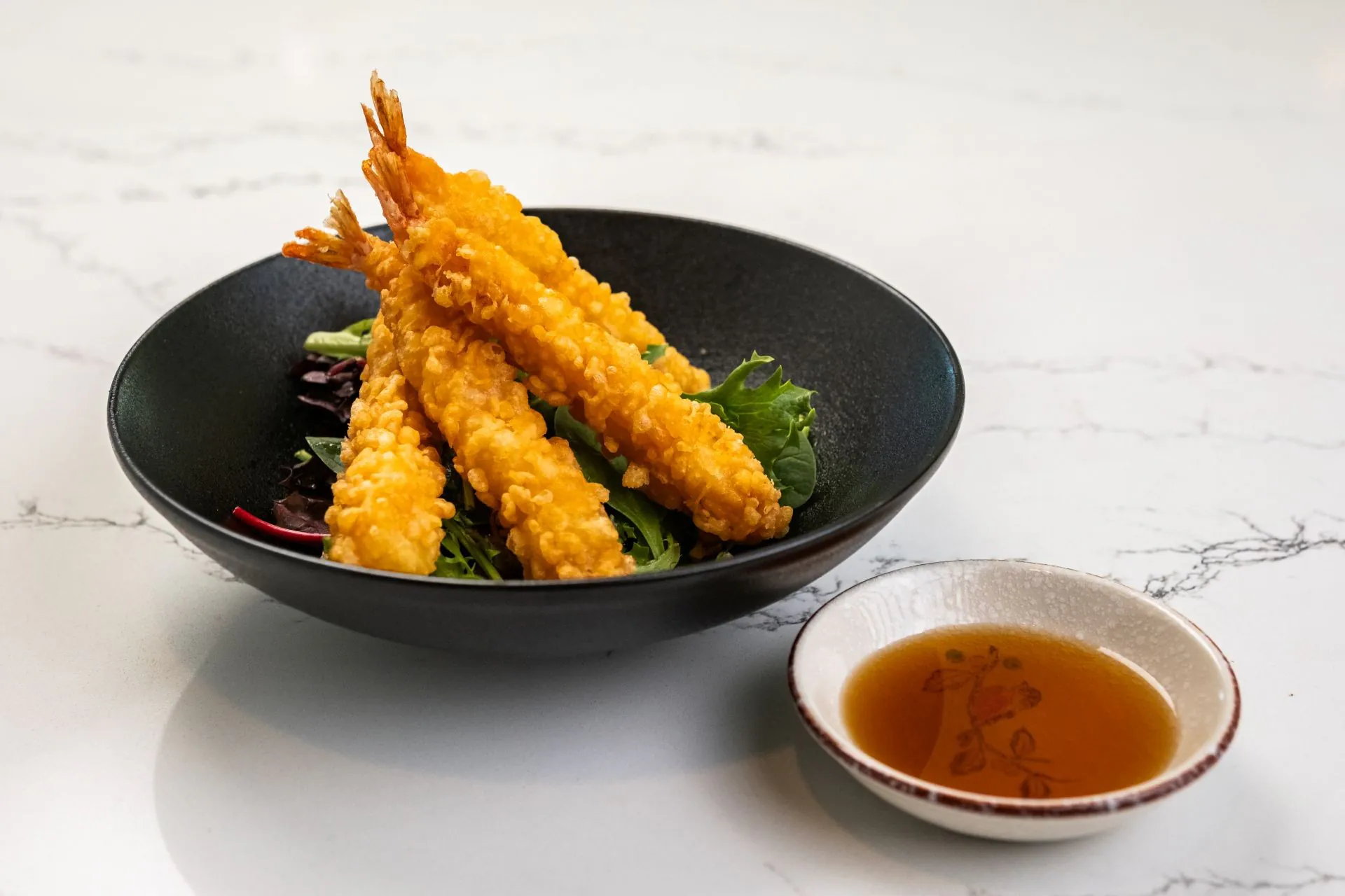 Crispy shrimp tempura with tempura dipping sauce at Toki Ramen & Sushi, a Japanese Restaurant in Denver