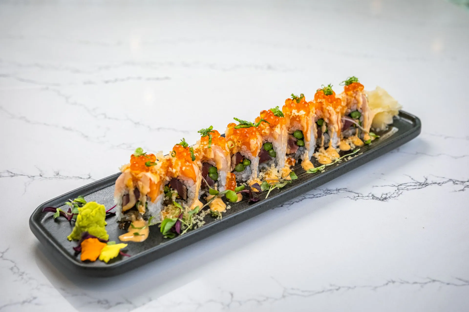 Salmon and tuna roll with tobiko, edamame and sauces at Toki Ramen & Sushi, a Japanese Restaurant in Denver