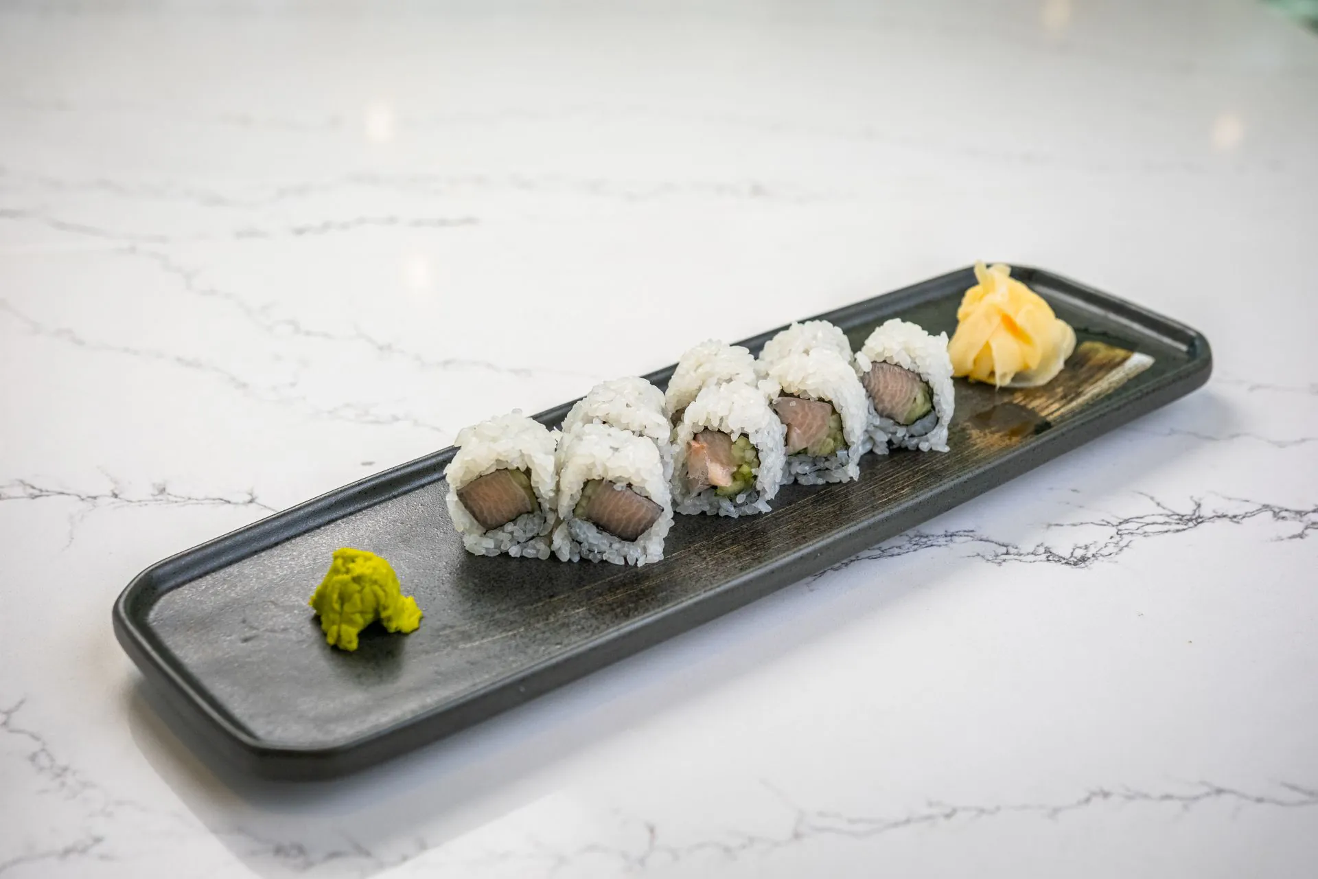 Salmon and avocado maki roll with wasabi and pickled ginger at Toki Ramen & Sushi, a Japanese Restaurant in Denver