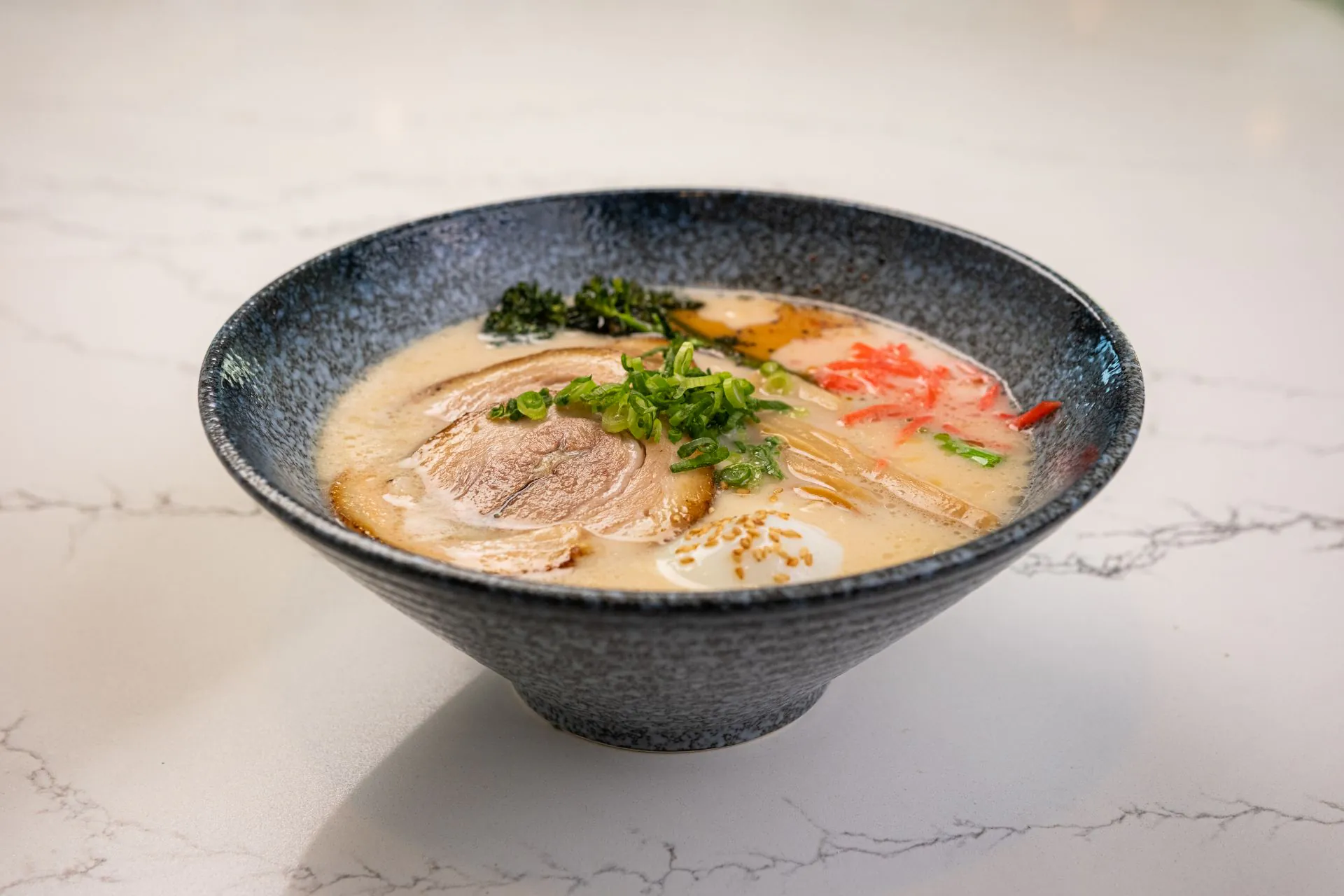 Creamy tonkotsu ramen with chashu, egg and green onions at Toki Ramen & Sushi, a Japanese Restaurant in Denver