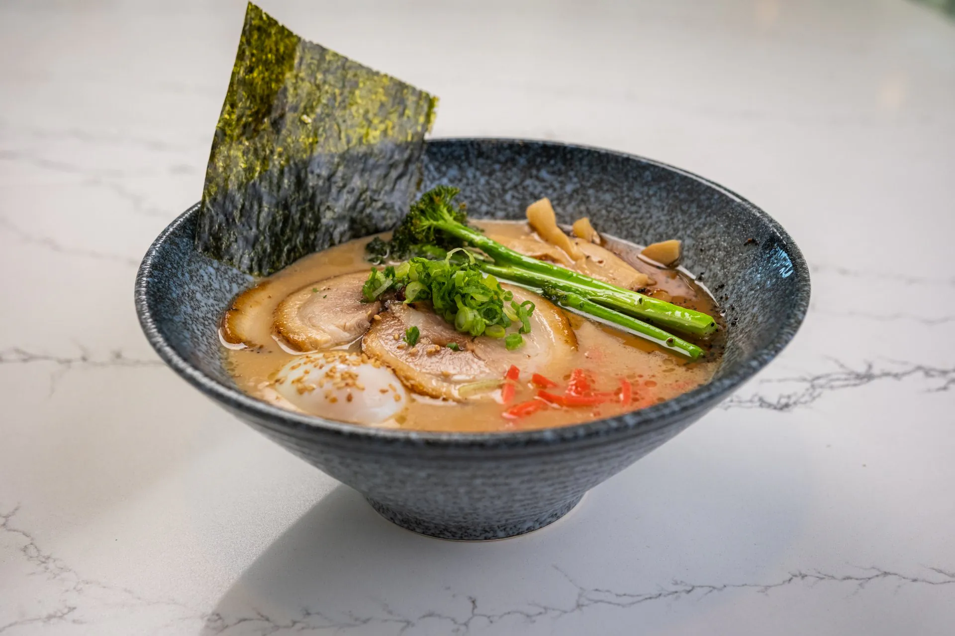 Spicy miso ramen with chashu, egg, broccoli and red pepper at Toki Ramen & Sushi, a Japanese Restaurant in Denver