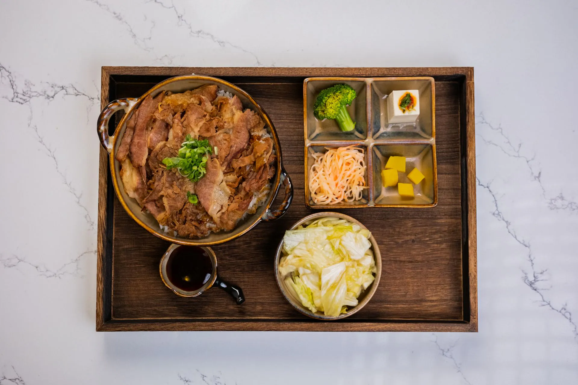 Beef rice bowl set with veggies and pickles at Toki Ramen & Sushi, a Japanese Restaurant in Denver
